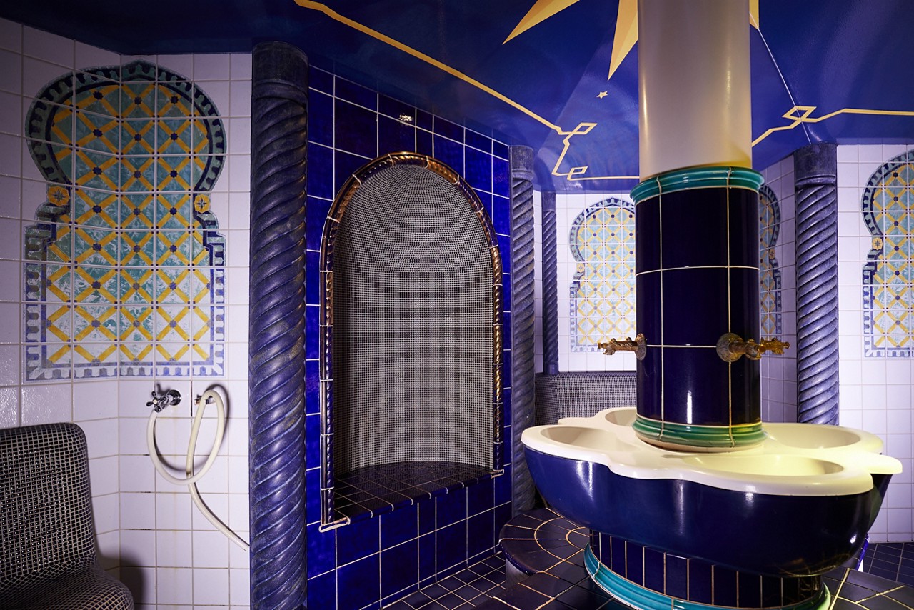 Decorative tiled Turkish Hammam with intricate designs on the walls.